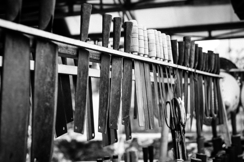 focus on foreground, knife, blade, steel, handle, vietnam, close-up, selective focus, cao bang, black smith, hanging, large group of objects, wood, built structure