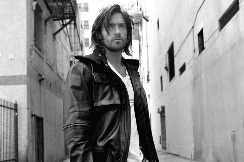 black and white photo, Hugh Jackman, built structure, jacket, casual clothing, 1080P, waist up, hair, s, look, architecture, leisure activity, one person