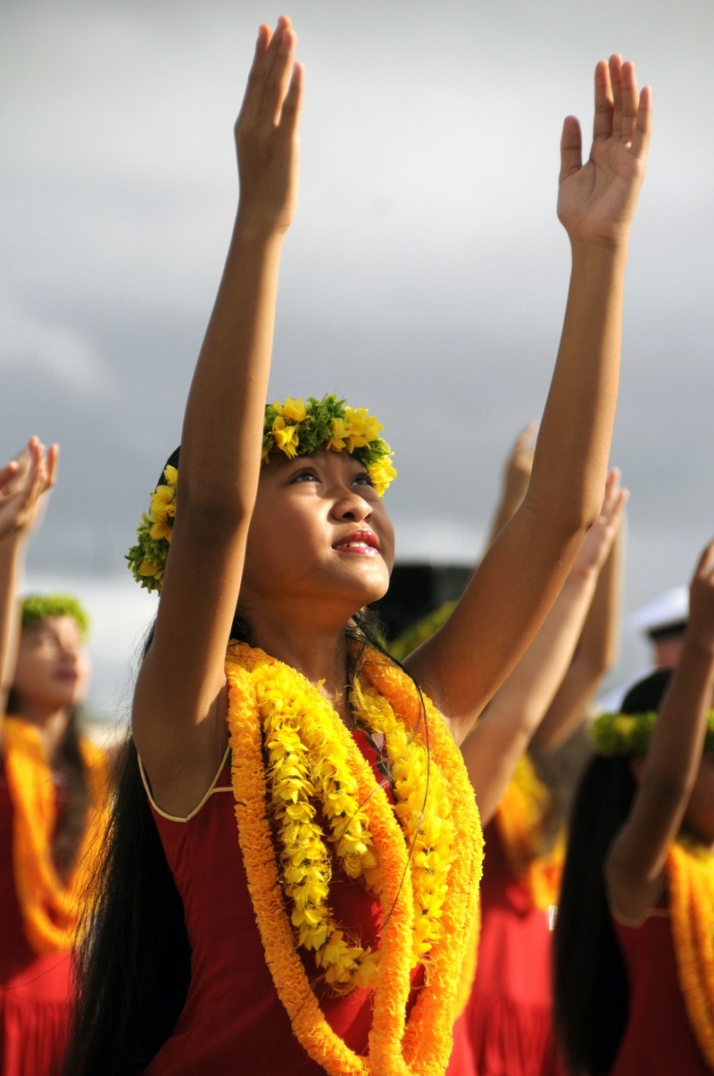 red, celebration, positive emotion, performance, excitement, focus on foreground, tropical, ethnic, hand raised, waist up, female, real people, sleeveless