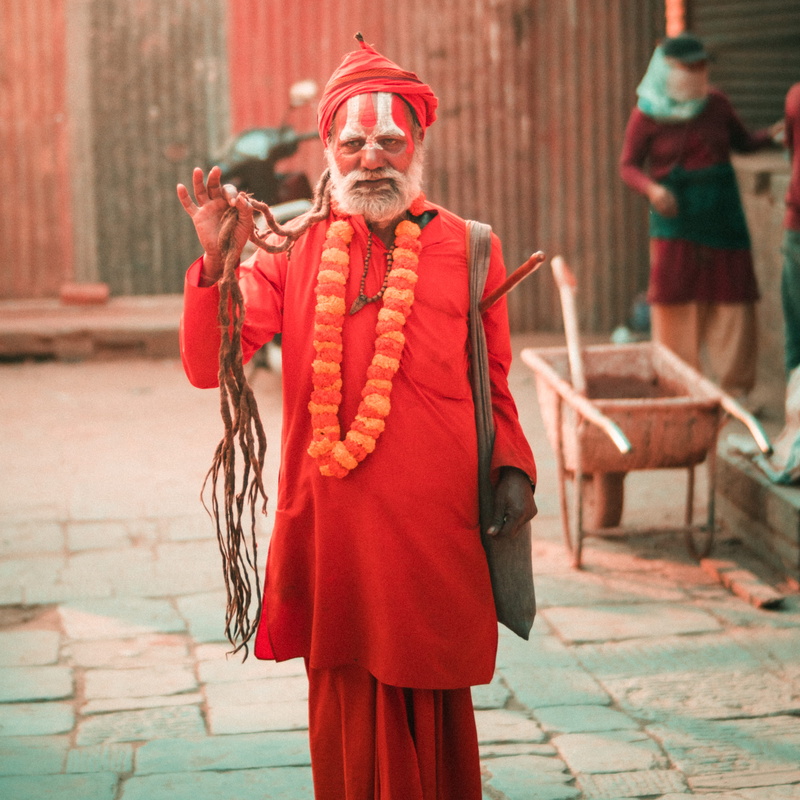 focus on foreground, hair, nepal, holding, men, hat, kathmandu, scarf, 4K, real people, person, day, monk, red, incidental people, standing, lifestyles