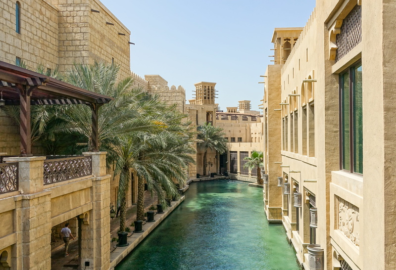 sidewalk, pool, houses, building, walkway, waterfront, city, palm, path, souk madinat jumeirah, architecture, gate, no people, water, masonry, sun, stonework