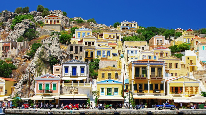 city, sunlight, large group of people, mountain, 1080P, architecture, outdoors, Symi, built structure, group of people, day, clear sky, nature, building exterior