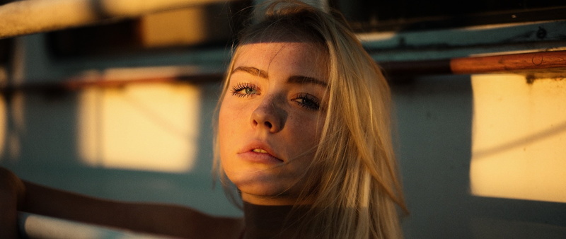 sadness, focus on foreground, hair, ultrawide, headshot, women, outdoors, looking at camera, looking, serious, close-up, beautiful woman, sunlight, front view