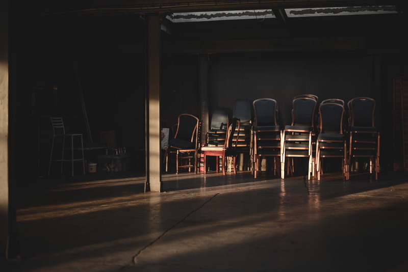 stage, floor, flooring, city, no people, chair, empty, contrast, built structure, lighting, room, space, biscuit factory, seat, hall, wood, indoors, wall