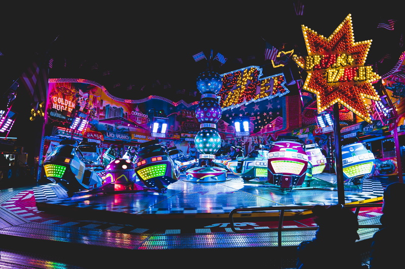 light, christmas decoration, vehicle, arcade game machine, parade, illuminated, carousel, human, architecture, carnival, celebration, crowd, lighting, amusement park