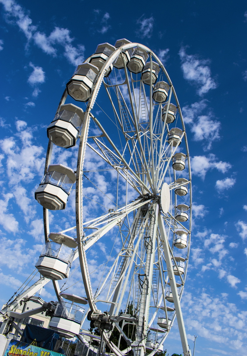 shape, fairground, fun, architecture, cloud - sky, festival, amusement park ride, outdoors, carousel, geometric shape, big wheel, fair, sunlight, carnival