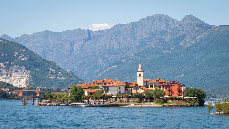 mountain range, travel destinations, place of worship, beauty in nature, city, waterfront, building, sea village, no people, house, land, nature, building exterior
