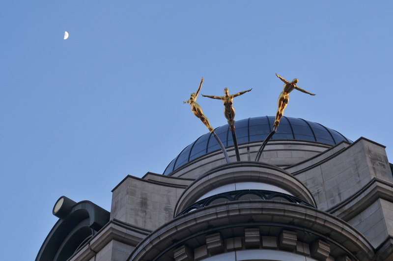 blue, building, clear sky, united kingdom, art and craft, low angle view, three gold swimmers, copy space, architecture, outdoors, building exterior, travel destinations