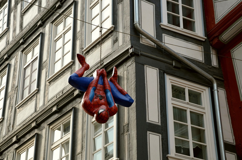 day, blue, outdoors, daytime, cartoon character, pedestrian zone, man, art and craft, city, spiderman, architecture, street, hanging, decor, built structure