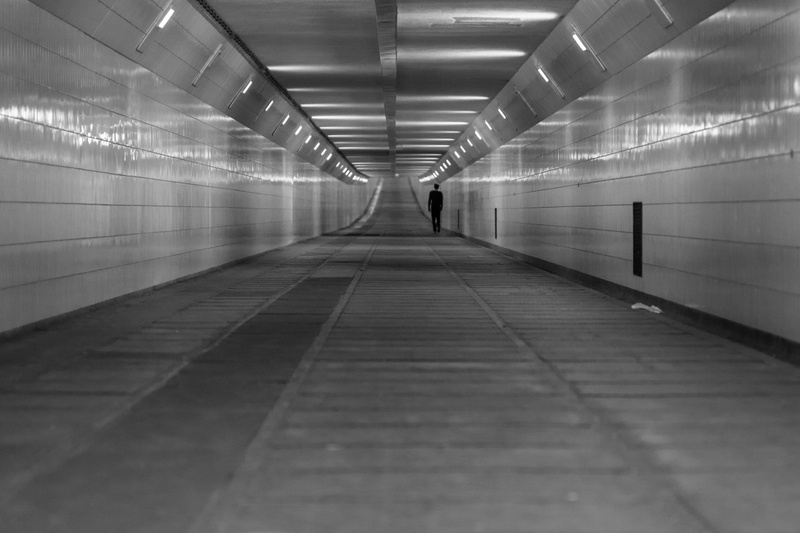 grayscale, indoors, transportation, wall - building feature, subway, real people, walking, diminishing perspective, flooring, the way forward, one person
