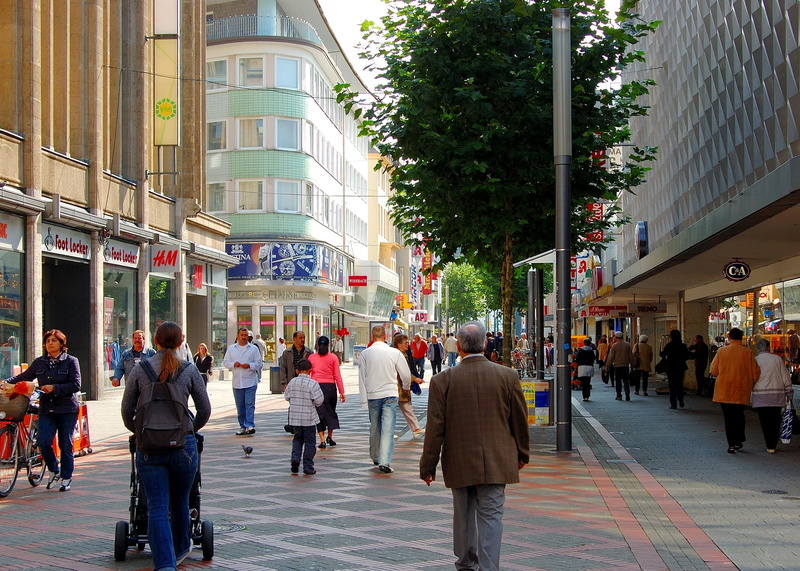 building exterior, buildings, large group of people, lifestyles, 2K, city street, people, city, crowd, outdoors, adult, shopping street, walking, real people