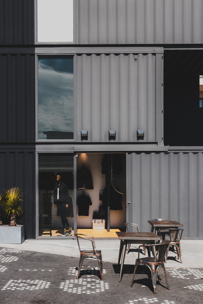 glass - material, empty, potted plant, chair, sitting, nature, restaurant, door, table, sky, folding door, bar counter, pub, day, outdoors, no people, architecture
