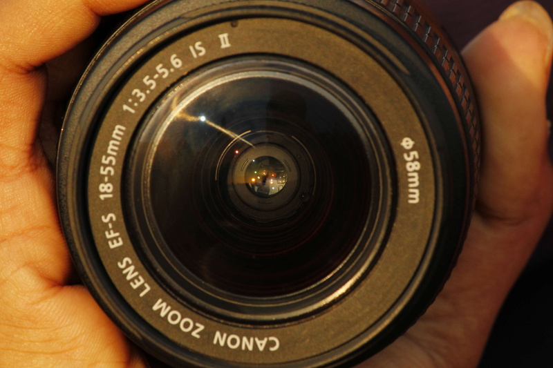photographic equipment, one person, holding, camera, lens - eye, human finger, hand, photography themes, human body part, a whole new world inside a lens