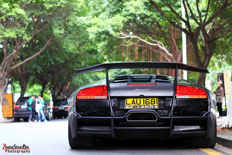 Lamborghini, outdoors, day, incidental people, city, tree, nature, mode of transportation, car, text, motor vehicle, road, Lamborghini Murcielago, land vehicle