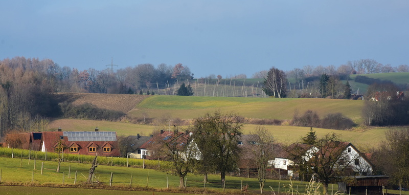 rural scene, arable, tranquil scene, nature, hill, farms, architecture, outlook, grass, lawn, plant, agriculture, built structure, field, panorama, beauty in nature