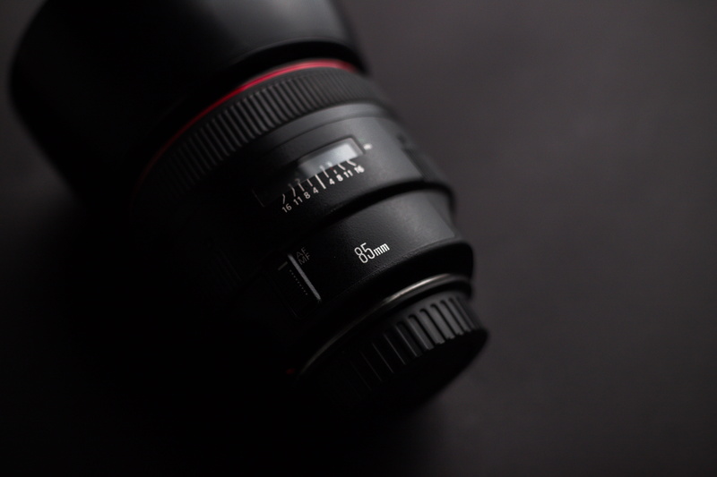 black background, single object, camera - photographic equipment, black, lens - eye, slr camera, lens - optical instrument, indoors, camera lens, high angle view