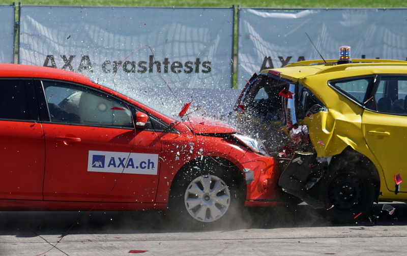 wet, motor vehicle, motion, red, airbag, safety test, machine, text, crash test, no people, city, street, mode of transportation, water, transportation system