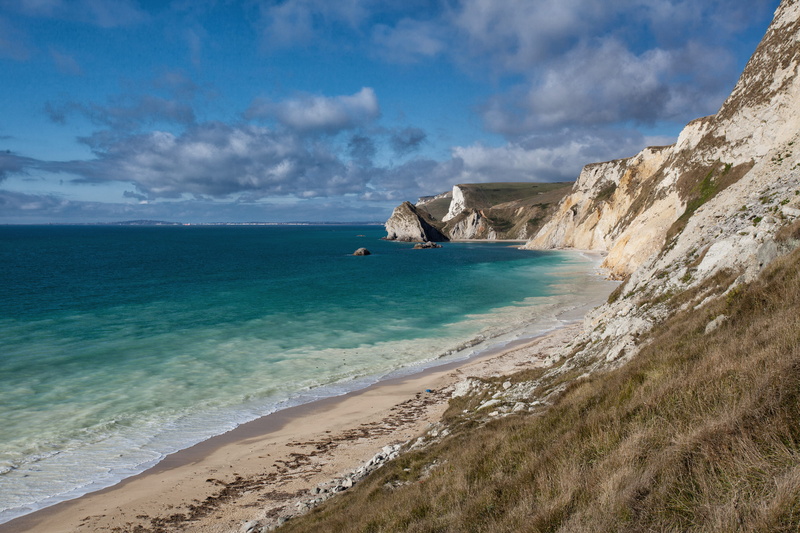 non-urban scene, beach, land, nature, Dorset, beauty in nature, cliff, vacations, turquoise colored, rock - Object, sand, shot, clouds, Jurassic Coast