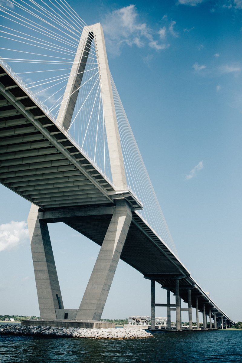 architecture, sunlight, travel destinations, city, architectural column, water, sea, nature, cable stayed bridge, sky, cloud - sky, 5K, low angle view