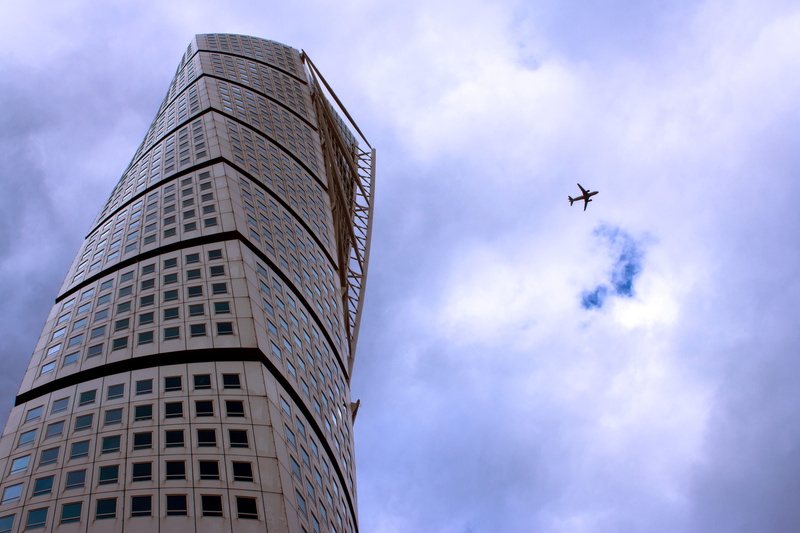 city, sky, built structure, nature, malmö, building, skyscraper, turning torso, tall - high, air vehicle, cloud - sky, low angle view, sweden, day, no people