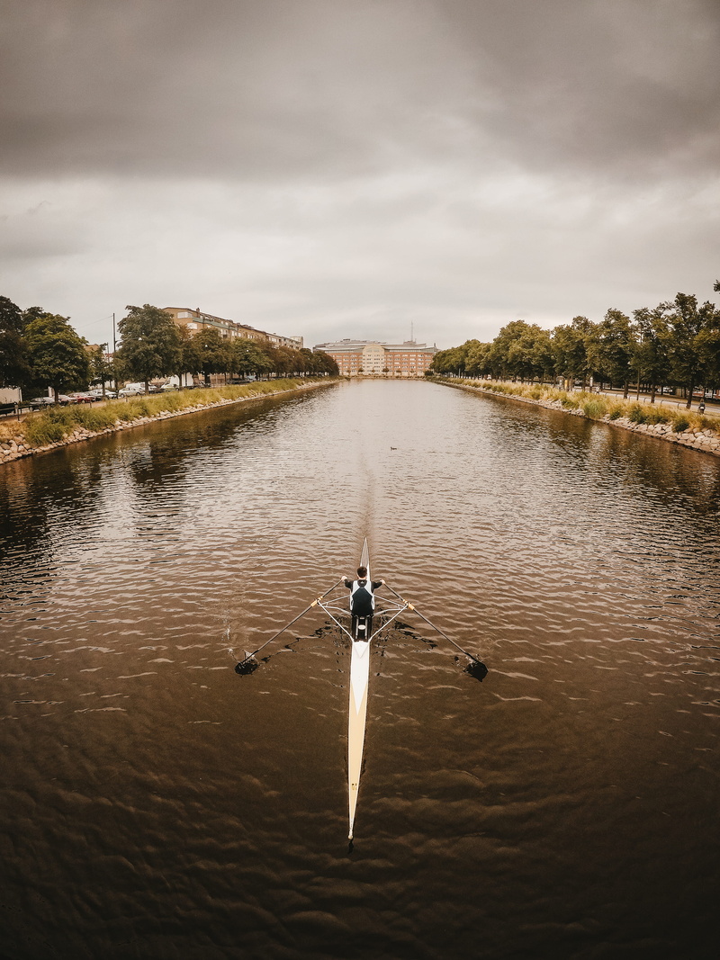 beauty in nature, riding, malmo, connection, architecture, waterfront, cloud - sky, river, paddle, leisure activities, sky, malmoe, water, mode of transportation