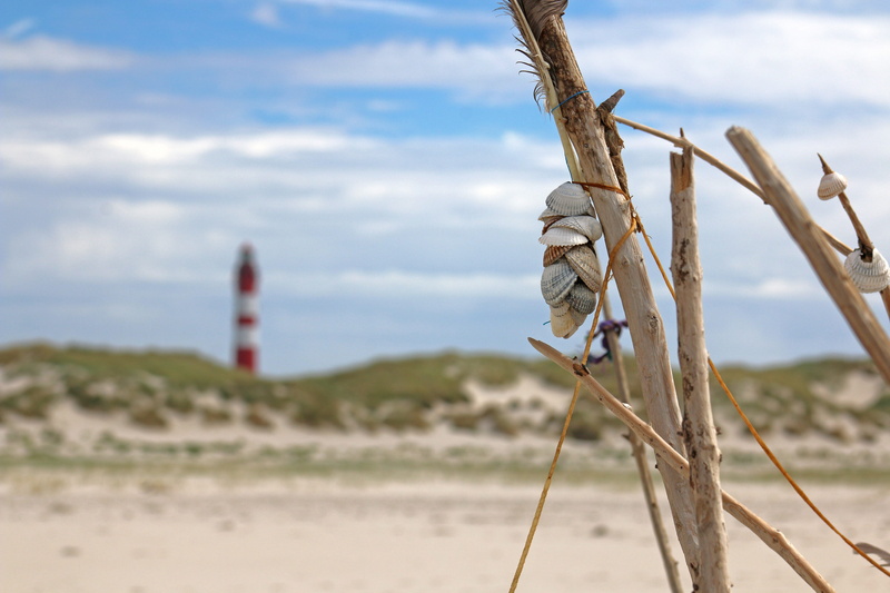 wooden post, outdoors, amrum, sand, nordfriesland, island, beauty in nature, beach, focus on foreground, tranquility, water, landscape, land, dunes, lighthouse