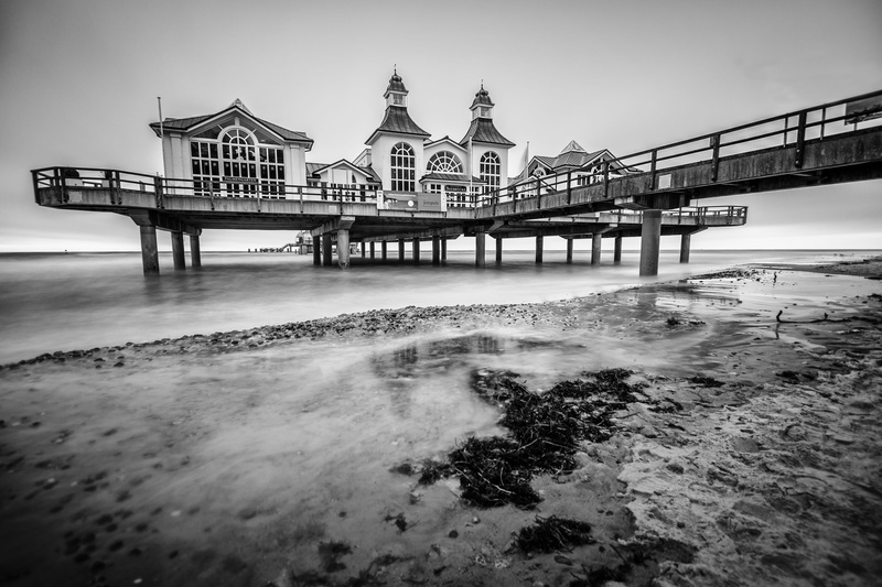 bridge - man made structure, outdoors, coast, building exterior, travel destinations, sky, black and white, water, connection, baltic sea, sea bridge, architectural column