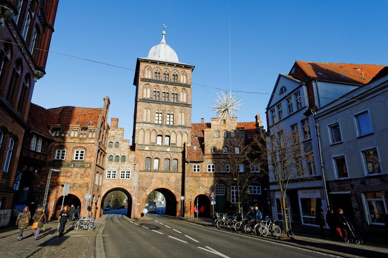 street, mode of transportation, building, transportation, hanseatic city, sky, downtown, architecture, travel, building exterior, blue, landmark, old town