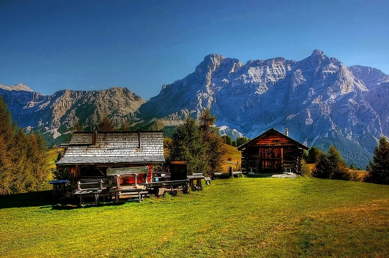 mountain hiking, grass, beauty in nature, mood, rock, environment, mountain range, field, meadow, landscape, distant view, architecture, nature, view, snowcapped mountain