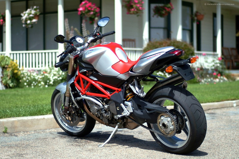 motorcycle, MV agusta, outdoors, sunlight, 480P, city, mode of transportation, helmet, scooter, street, built structure, black color, motor scooter, transportation