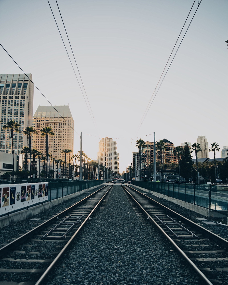 skyscraper, long, urban, railroad tracks, mode of transportation, sky, 2K, architecture, clear sky, sun, transportation, marina, seaport village, connection