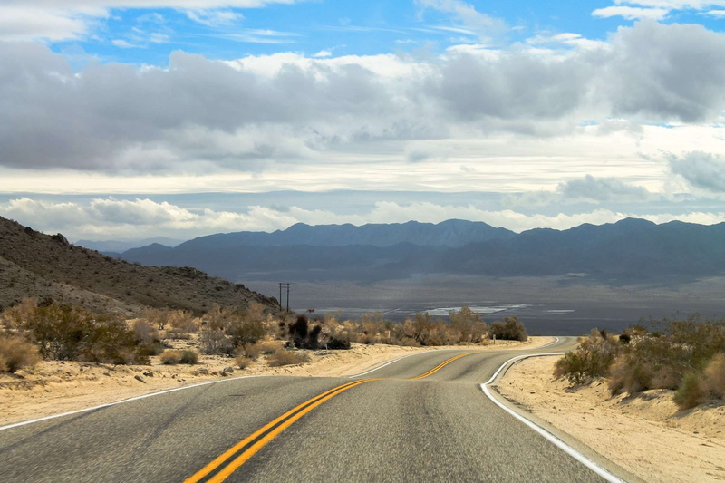 tranquil scene, car, highway, beauty in nature, tranquility, cloud - sky, dividing line, landscape, architecture, national, symbol, city, california, day