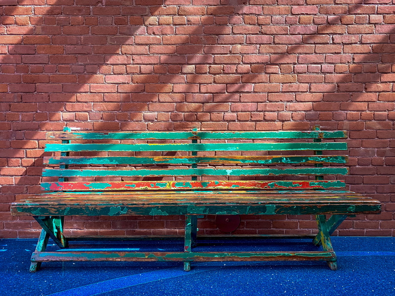 bike, built structure, astronaut, shadows, day, park bench, outdoors, relaxation, mural, empty, ping pong, plaque, transportation, textures, sitting, wall - building feature