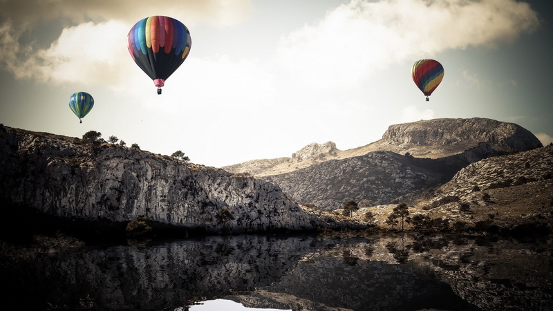 water, rock formation, hot air balloon, balloon, adventure, transportation, lake, mountain range, flying, mid-air, outdoors, formation, solid, scenics - nature