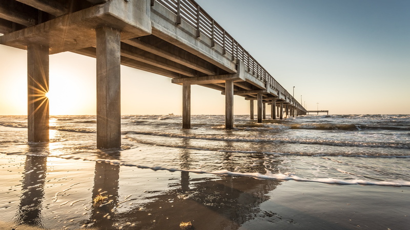 sunset, built structure, dock, underneath, reflection, beach, nature, sky, horizon over water, beauty in nature, bridge - man made structure, sun, scenics - nature
