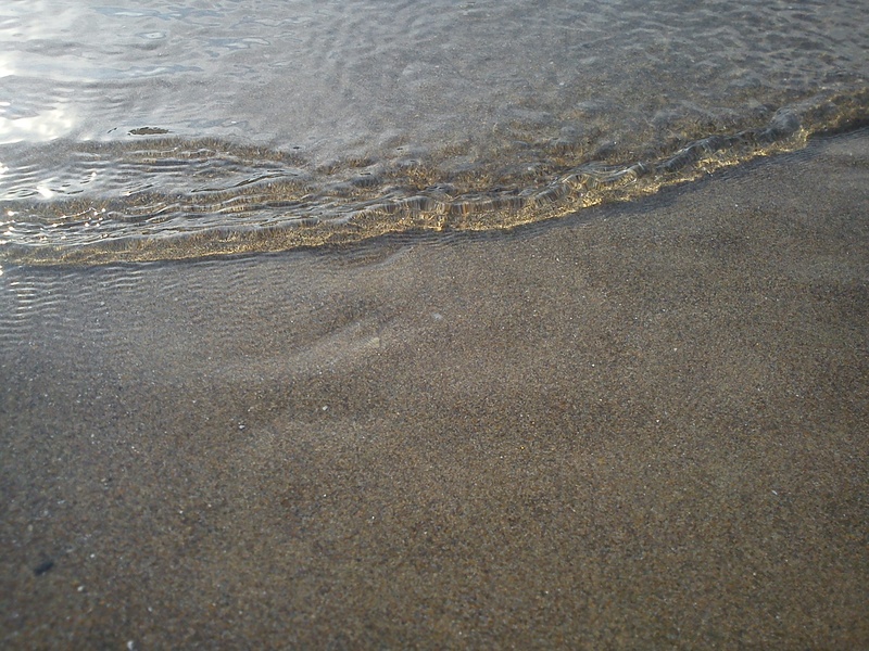 sea, tranquility, beach, wet, aquatic sport, water, high angle view, smooth, nature, sand beach, clear, light, land, outdoors, motion, wave, full frame