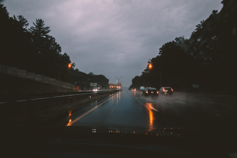 highway, asphalt, travel, morning, vehicle interior, mode of transportation, wet, street lights, tree, storm, motor vehicle, outdoors, illuminated, reflections