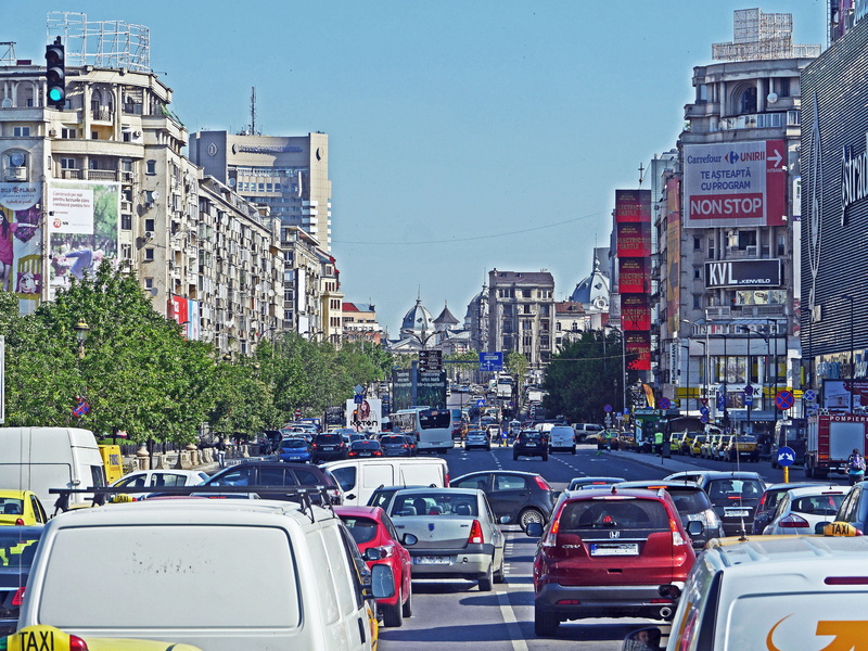 car, building exterior, built structure, pkw, street, jam, road, traffic, sky, houses, house facade, building, travel, transporter, facade, outdoors, one way street