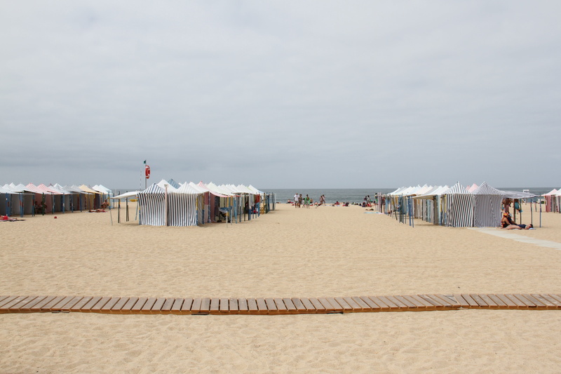 scenics - nature, incidental people, travel, architecture, ocean, horizon, tent, tranquility, sea, nazaré, day, beach, sand, nature, building exterior