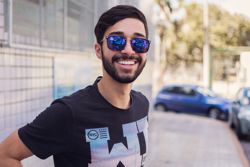 focus on foreground, front view, confidence, style, glasses, 5K, smile, looking, portrait, adult, fine-looking, fashion, outdoors, happy, guy, depth of field