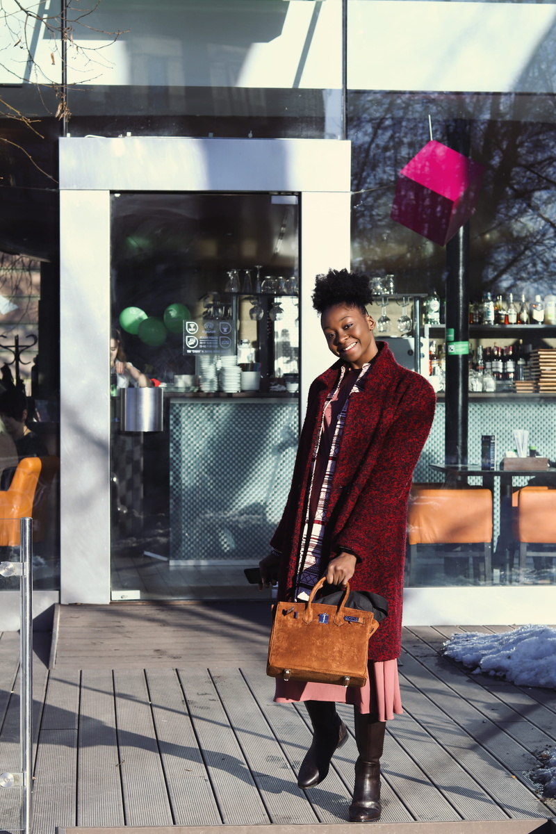 style, city, smile, red, looking at camera, one person, urban, dress, 5K, woman, young adult, day, clothing, young, shopping, coat, casual clothing, standing