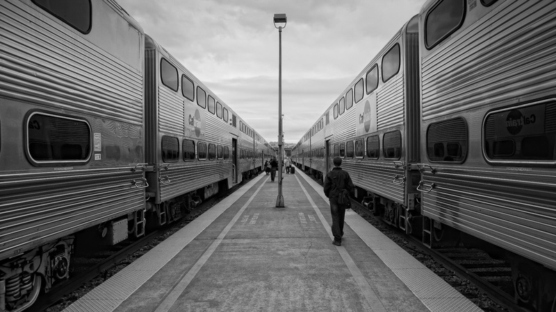 monochrome, outdoors, train station, incidental people, travel, passenger train, track, sky, train - vehicle, railroad track, diminishing perspective, rail transportation