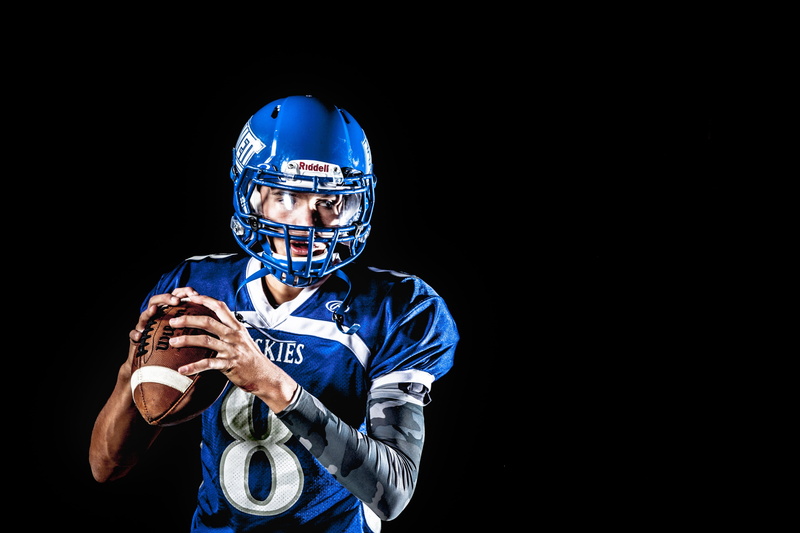 american football - ball, studio shot, adult, sport, 4K, headwear, front view, aggression, quarterback, blue, sports equipment, uniform, sportsman, looking at camera