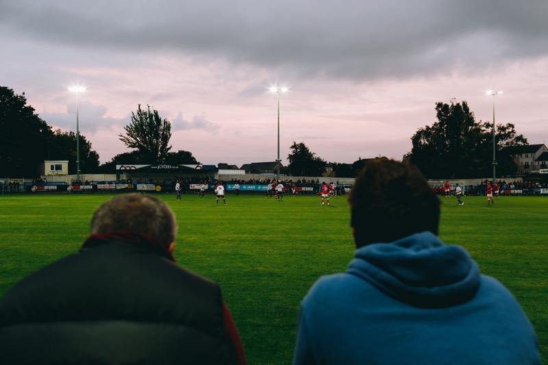 football, group of people, stadium, culture, hoodie, grass, lifestyles, sport, guiseley, tree, field, cloud - sky, sitting, betting, floodlights, leisure activity