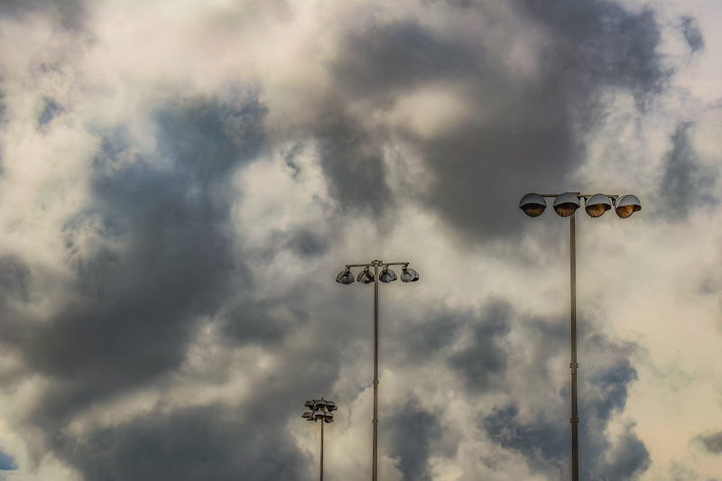 outdoors, cloud - sky, tall - high, electric lamp, light, stormy weather, technology, street, pole, sky, storm, metal, low angle view, floodlight, no people