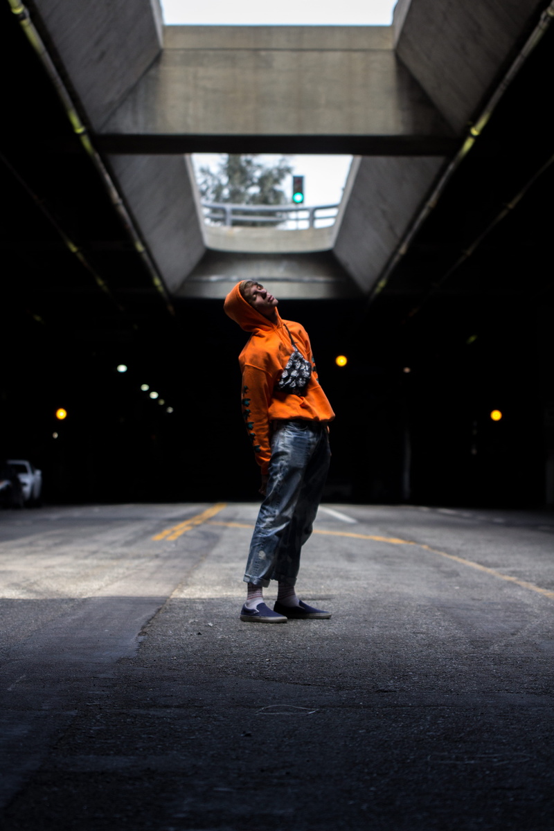 hoodie, orange hoodie, road, full length, pose, jeans, person, casual clothing, mystic, black, illuminated, one person, light, sign, men, lifestyles, lot