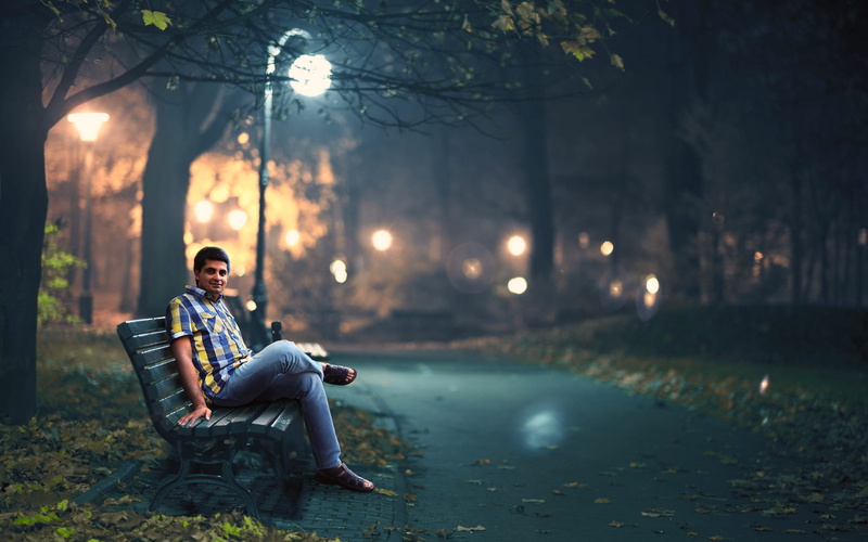 plant, leisure activity, full length, post, night, one person, focus on foreground, 2K, bench, front view, blue, lamp, casual clothing, men, park, young adult
