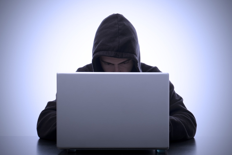 typing, surfing the net, leisure activity, computer, computer crime, lifestyles, wireless technology, hood, man, one person, indoors, front view, hood - clothing
