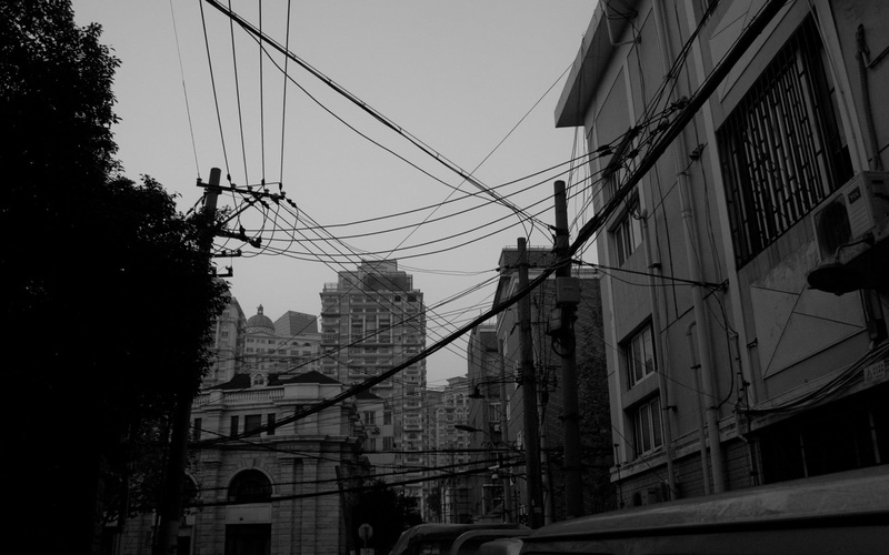 building, cityscape, clear sky, sky, architecture, electricity, connection, technology, residential district, gray, monochrome, low angle view, overcast