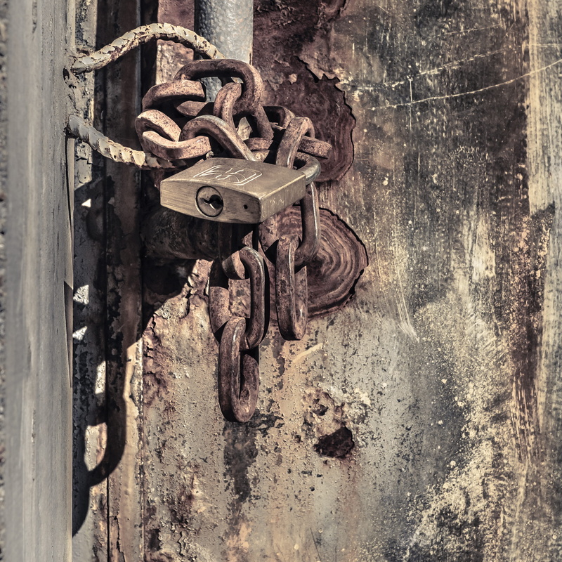 no people, wall clock, outdoors, sign, hanging, chain, gear, textured, closed, safety, metal, iron, day, harness, road sign, lock, clock, entrance, padlock